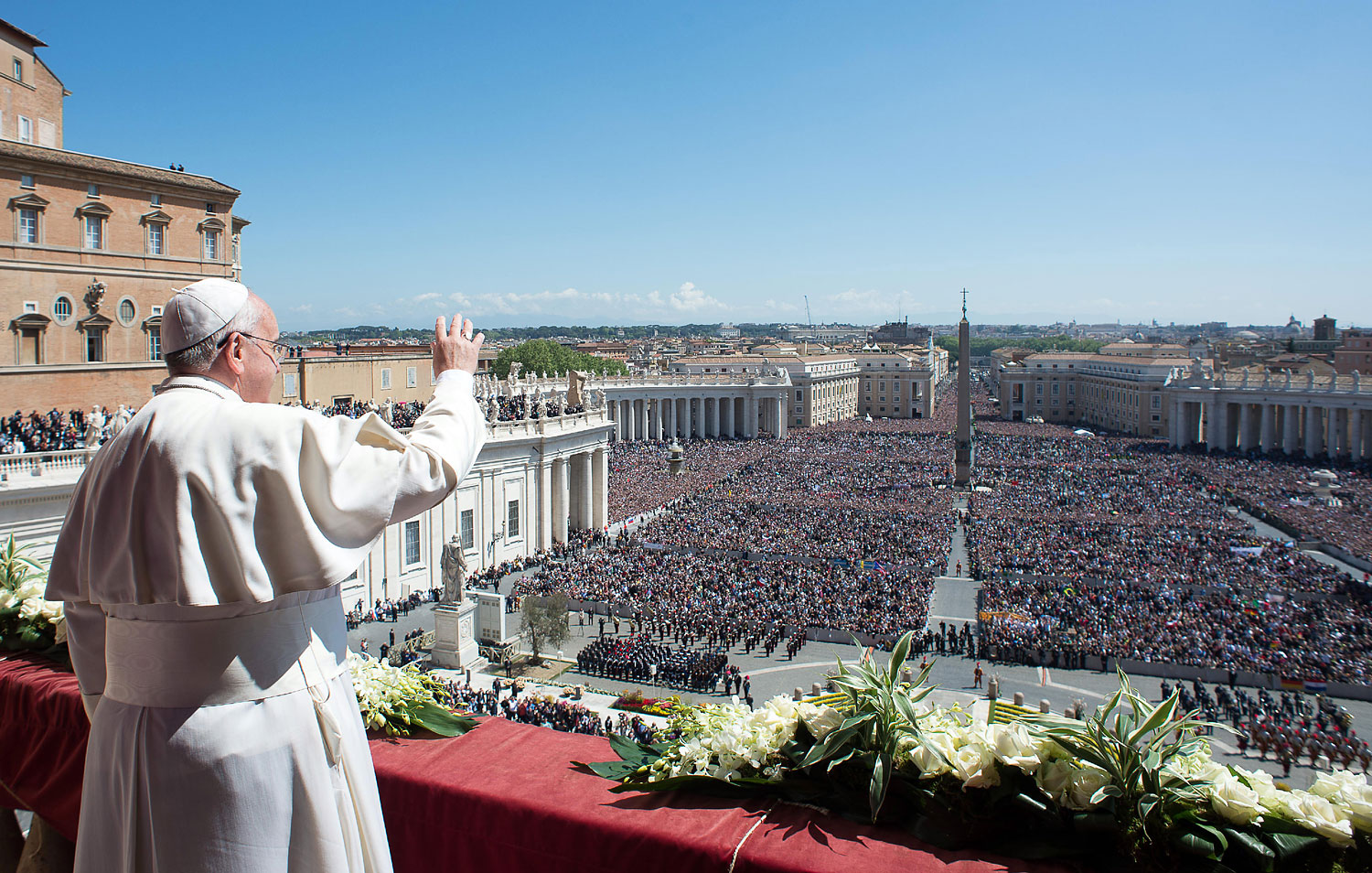 Pope Francis waves to the crowd from the balcony of St. Peter's Basilica in 2014