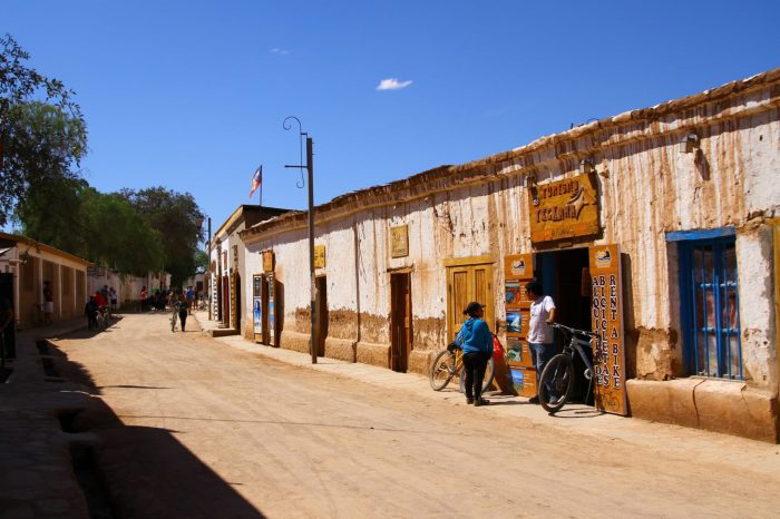 two people talk in a dirt road in chile